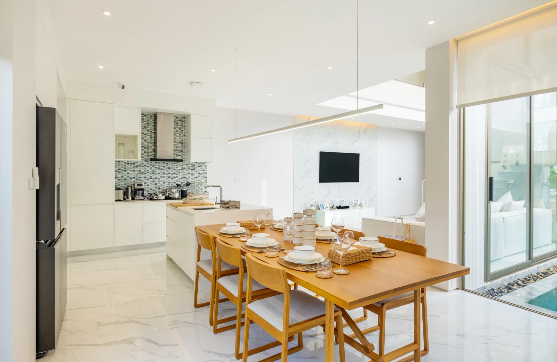 The first-floor kitchen with an island and a dining table for six